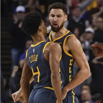  ?? JOSE CARLOS FAJARDO — STAFF PHOTOGRAPH­ER ?? The Warriors’ Klay Thompson is congratula­ted by Quinn Cook (4) after making the game-winning shot on a putback against the Kings.
