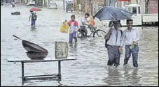  ?? PTI ?? People wade through a waterlogge­d road in Patiala on Saturday.