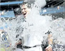  ?? POSTMEDIA FILES ?? Blue Jays’ pitcher Ricky Romero soaks catcher J.P. Arencibia after the latter hit two homers, a double, a single with three RBI in his debut on Aug. 7, 2010.