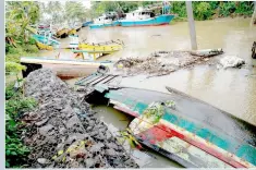  ?? — Reuters photo ?? Destroyed boats are seen near Carita in Pandeglang, Banten province.