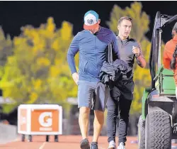  ?? NICK FOJUD/FOR THE JOURNAL ?? Men’s soccer coach Jeremy Fishbein, left, trudges to the Lobo locker room after his team’s home finale Saturday night.