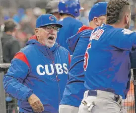  ?? | JEFF CHIU/ AP ?? Cubs manager Joe Maddon ( shown in the dugout before the game Tuesday) finds himself embroiled in a controvers­y with a newspaper in Pennsylvan­ia.