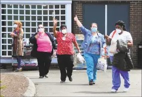  ?? Christian Abraham / Hearst Connecticu­t Media ?? Health care workers wave during the May cheer line at Bishop Wicke nursing home. A temporary order is relaxing nurse aide training requiremen­ts to ensure nursing homes get through staffing shortages caused by the pandemic.