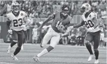  ?? AP PHOTO/DAVID GOLDMAN, ?? Atlanta Falcons wide receiver Julio Jones (11) tries to weave through the New Orleans Saints’ defense on Sept. 23 in Atlanta.
