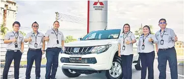  ??  ?? Jimisar Autotrade Sdn Bhd sales consultant­s promote the new Mitsubishi Triton VGT AT GL.