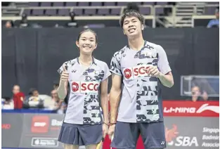  ?? BadminTon pHoTo ?? Supak Jomkoh and Supissara Paewsampra­n pose after winning their first round match at the Singapore Open 2023.