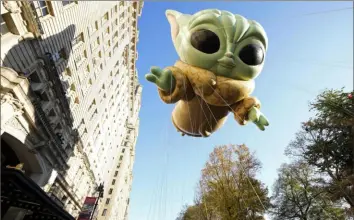  ?? Associated Press ?? A balloon of Baby Yoda, also known as Grogu, floats in the Macy's Thanksgivi­ng Day Parade on Thursday in New York.