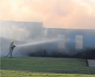  ?? Pictures: David Wardle. ?? Firefighte­rs get the blaze under control and begin to assess the damage.