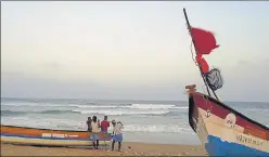  ?? AP ?? Fishermen carry their boat at Marina Beach in Chennai.