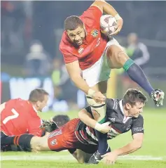  ??  ?? British and Irish Lions’Taulupe Faletau (top) looks to break a tackle during the rugby match against New Zealand’s Provinial Barbarians at Toll Stadium in Whangarei in this June 3 file photo. — AFP photo