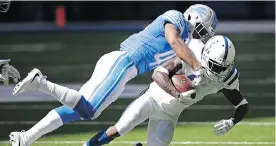  ?? THE ASSOCIATED PRESS ?? Indianapol­is’s JoJo Natson, right, is tackled by Detroit’s Charles Washington during the second half of their NFL game Sunday in Indianapol­is.