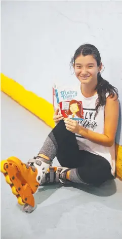  ?? Picture: BRENDAN RADKE ?? TIME OUT: Marina Palka, 15, reads the Enid Blyton novel Malory Towers — First Term at the Cairns skating centre at Manunda.