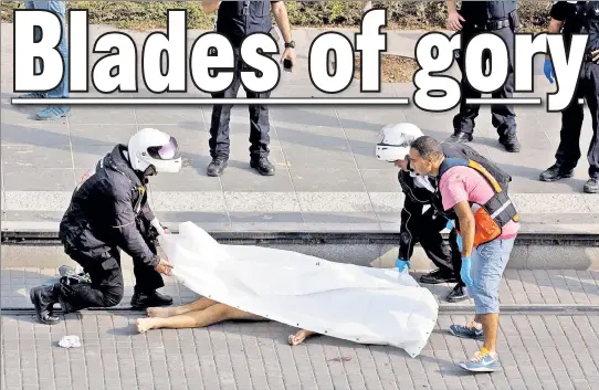  ??  ?? BLOODY DAY: Israeli cops cover the body of a Palestinia­n boy who was shot dead after stabbing two Israelis in East Jerusalem Monday.