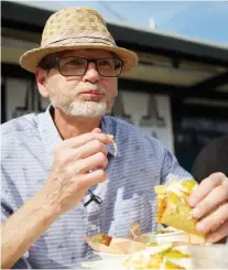  ?? MATT OLSON FILES ?? Cam Fuller tries a taco during the Foodtruck Wars Flavour Challenge this past summer. Food taster was one of his many hats.