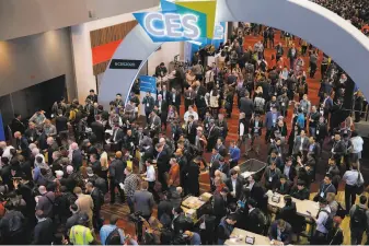  ?? John Locher / Associated Press 2020 ?? Crowds enter the show in Las Vegas last year. The pandemic has forced a virtual show this year.