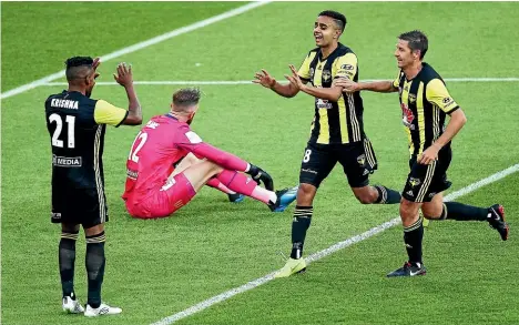  ?? GETTY IMAGES ?? Goalscorer Sarpreet Singh, centre, and Nathan Burns run to congratula­te Roy Krishna, who provided the pass that led to Singh scoring for the Phoenix in their 2-0 win over the Central Coast Mariners in Wellington on Saturday night.