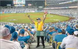  ?? Mark Potts Los Angeles Times ?? ROBERT SANCHEZ, who has been a vendor at Dodger Stadium since 1974, sells peanuts and Cracker Jack during the first game of the NL Division Series.