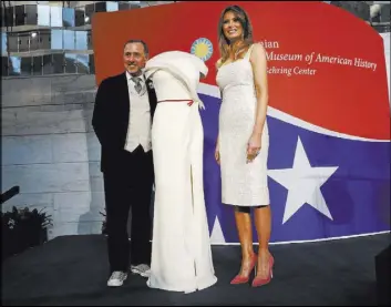  ?? Pablo Martinez Monsivais The Associated Press ?? First lady Melania Trump donates her inaugural gown, designed by Herve Pierre, left, to the First Ladies Collection at the Smithsonia­n’s National Museum of American History during a ceremony Friday in Washington.