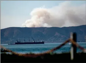  ?? (AP/Noah Berger) ?? Seen from Alameda, Calif., a grass fire burns Friday in San Francisco as portions of hot and dry Northern California remain under red flag fire warnings.