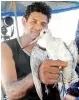  ??  ?? Dr. Sampath Seneviratn­e with a Banded Bar-tailed Godwit - a rare find in Sri Lanka