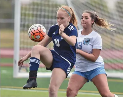  ?? Dan Watson/The Signal (See additional photos on signalscv.com) ?? West Ranch’s Morgan Gale (10) takes a pass near the goal against Madi Jacques (13) of Crescenta Valley at West Ranch High on Thursday. The Wildcats battled rain throughout the contest against the Falcons.