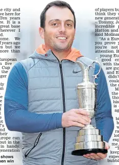  ??  ?? JUG’S AWAY: Molinari shows off the spoils of his Open win