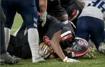  ?? Pittsburgh Post-Gazette ?? Aliquippa’s Braylon Wilcox recovers a fumble for a touchdown against Central Valley during the first quarter of the WPIAL Class 4A football championsh­ip on Friday at Acrisure Stadium.