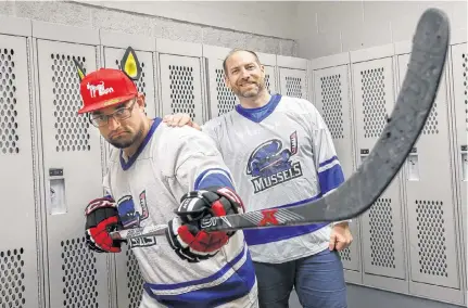  ?? TIM KROCHAK THE CHRONICLE HERALD ?? Halifax Mussels players Tristan Laan (left) and Chuck Dauphinee, who is also the team founder, in a dressing room in Halifax. The team was created with the aim to provide a safe space to all LGBTQ+ hockey players and allies.
•