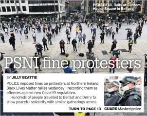  ??  ?? PEACEFUL Rally at Custom House Square in Belfast
GUARD Masked police