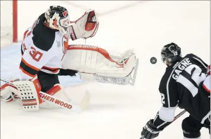  ?? WALLY SKALIJ/ LOS ANGELES TIMES ?? New Jersey Devils goalie Martin Brodeur turns away a shot by Los Angeles Kings left- winger Simon Gagne during Game 4 at Staples Center in Los Angeles Wednesday. Brodeur has played in 203 playoff games, the equivalent of two and a half seasons.