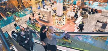  ?? MARY ALTAFFER/AP PHOTOS ?? Customers ride the escalators designed by Dutch architect Rem Koolhaas at the Saks Fifth Avenue Flagship in New York.