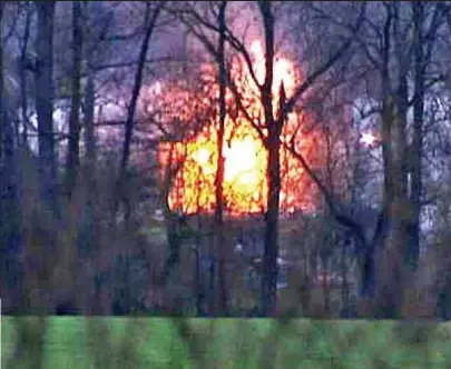  ??  ?? Blaze: The explosion, as seen through nearby trees. Local residents said they felt the ground shake
