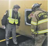  ?? PHOTOS BY JOHN MCCASLIN ?? “We were lucky there weren’t more serious injuries,” Sheriff Connie Compton said while surveying the flipped bus.