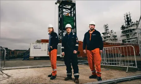  ??  ?? Lead engineer Miles Franklin, centre, with staff from Dutch winch specialist Huisman at Gravitrici­ty’s Port of Leith test facility in Edinburgh