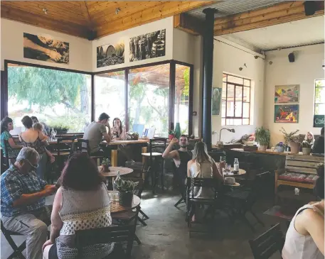  ?? PHOTOS: SARa LIEBERMAN/FOR THE WASHINGTON POST ?? Visitors enjoy a meal at Assaf Winery’s Adika Cafe in the Golan Heights.