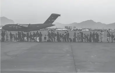  ?? SGT. ISIAH CAMPBELL/U.S. MARINE CORPS ?? Evacuees wait to board a C-17 Monday at Hamid Karzai Internatio­nal Airport in Kabul, Afghanista­n.