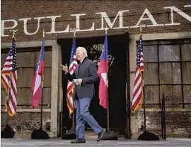  ?? PATRICK SEMANSKY Associated Press ?? PRESIDENT- ELECT Joe Biden walks onstage at a drive- in rally in Atlanta for Raphael Warnock and Jon Ossoff, Democratic candidates for the U. S. Senate.