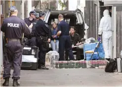  ??  ?? SYDNEY: Police collect evidence outside a house in the inner Sydney suburb of Surry Hills yesterday after it was raided in a major joint counter-terrorism operation. — AFP