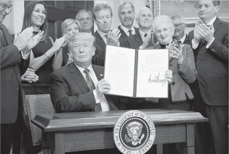  ?? Alex Wong Getty Images ?? GOP REP. Virginia Foxx, third from right, and Sen. Rand Paul, sixth from right, join President Trump as he signs a healthcare order.