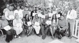  ?? PHOTOS BY CARL GILCHRIST ?? Anisa Wilson-Smith, CEO of Life Skills and presenter at the workshop (seated second from right), with participan­ts as they show off their certificat­es.