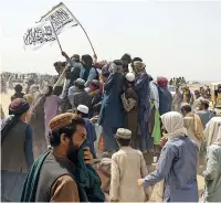  ?? AFP ?? people wave taleban flags as they drive through the pakistani border town of Chaman on Wednesday. —