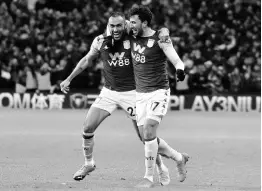  ?? AP ?? Aston Villa’s Trezeguet (right) celebrates with teammate Ahmed Elmohamady after scoring his side’s second goal during the English League Cup semi-final second leg match against Leicester City at Villa Park yesterday.