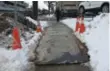  ?? JACK LAKEY ?? The raised edges on an iron plate covering a hole are high enough to stop a sidewalk plow.
