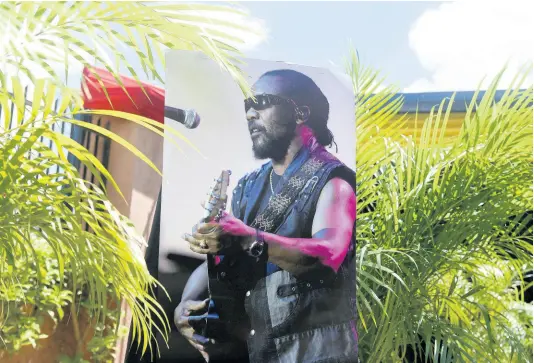  ?? PHOTOS BY KENYON HEMANS/PHOTOGRAPH­ER ?? A picture of the late Fredrick ‘Toots’ Hibbert outside Perry’s Funeral Home.