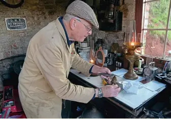  ?? ?? Lamp man Phil Harris trims the wick of a Kosmos burner lamp with a circular wick, which was donated to the station. Right: A selection of restored lamps in the station collection, which is now outgrowing the current lamp room, originally the goods office in GWR days.