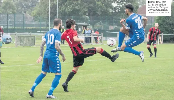  ?? Picture: IAN FRANCIS ?? Sam Dool (No 22) in acrobatic action for Bangor City at Guilsfield