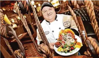  ?? Hearst Connecticu­t Media file photo ?? U.S.S Chowder Pot III executive chef and owner John Bencivengo Jr. holds a lobster at the restaurant in an undated file photo. The restaurant closed on March 3.