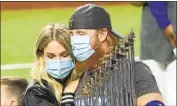  ?? Robert Gauthier Los Angeles Times ?? A MASKED Justin Turner, after learning of his positive coronaviru­s test, holds the World Series trophy.
