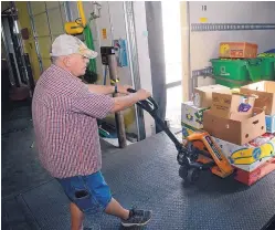  ??  ?? Teddy Coombs unloads his truck at the Roadrunner Food Bank Albuquerqu­e. Coombs is getting on-the-job training through Roadrunner’s SecTeddy ond Chances program.