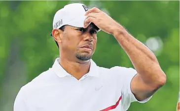  ?? AP ?? Tiger Woods waits to tee off on the 11th hole.